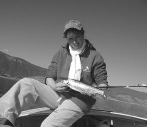 An average trout caught and released in the bay behind the author on a gold Jackall. 